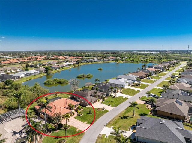 drone / aerial view featuring a residential view and a water view