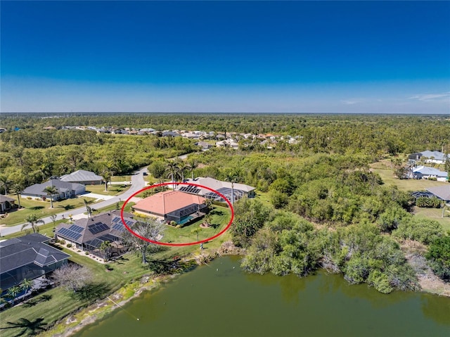 bird's eye view featuring a wooded view and a water view