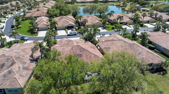 drone / aerial view featuring a residential view and a water view