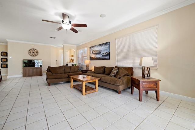 living area with light tile patterned floors, ceiling fan, crown molding, and baseboards