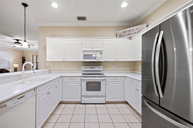 kitchen featuring a sink, white appliances, ornamental molding, and light tile patterned floors