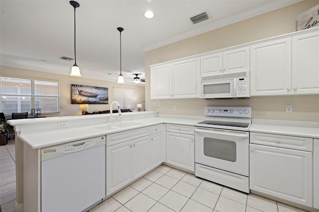 kitchen featuring visible vents, ornamental molding, a peninsula, white appliances, and a sink