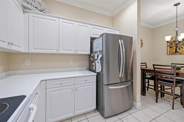 kitchen featuring crown molding, freestanding refrigerator, hanging light fixtures, a notable chandelier, and white cabinets