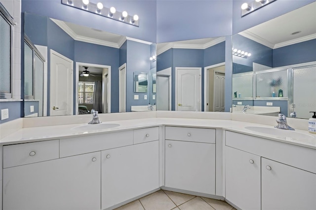 bathroom featuring crown molding, tile patterned floors, and a sink