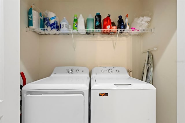 clothes washing area featuring laundry area and washing machine and clothes dryer