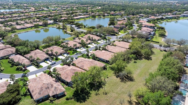 bird's eye view featuring a residential view and a water view