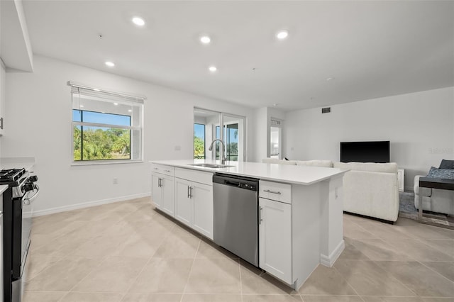 kitchen featuring a sink, light countertops, white cabinets, gas range oven, and stainless steel dishwasher