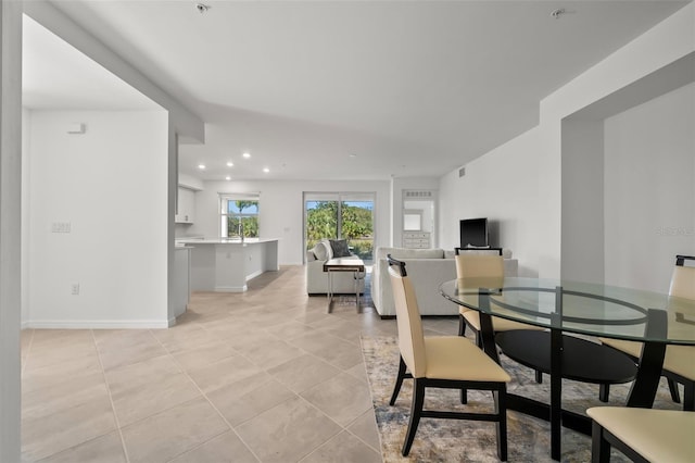 dining room featuring light tile patterned floors, baseboards, and recessed lighting