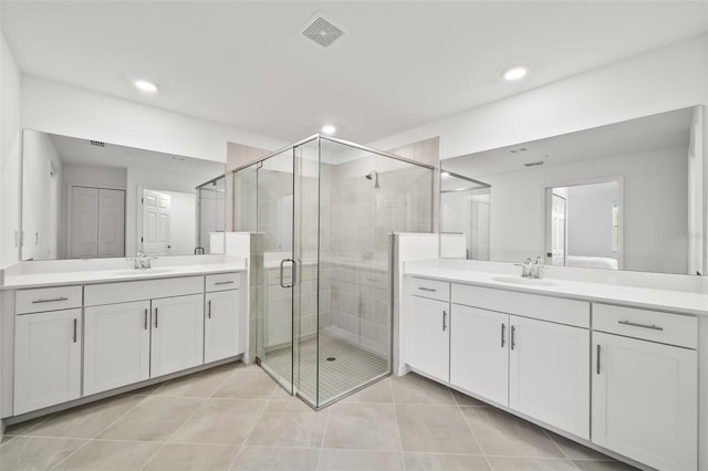 bathroom featuring a sink, visible vents, and a stall shower