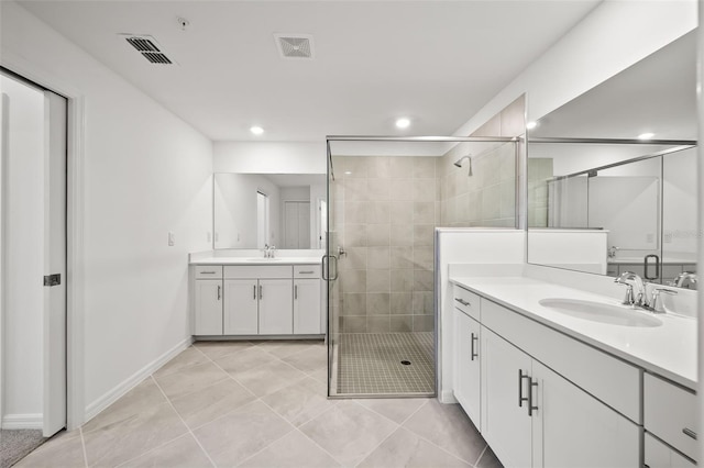 full bathroom featuring visible vents, a stall shower, and a sink