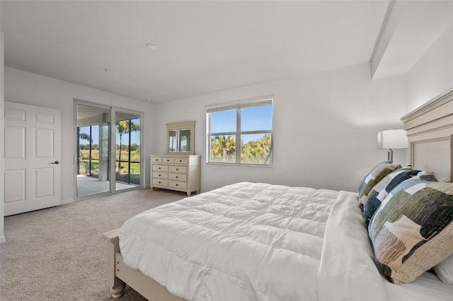 carpeted bedroom featuring multiple windows and access to outside