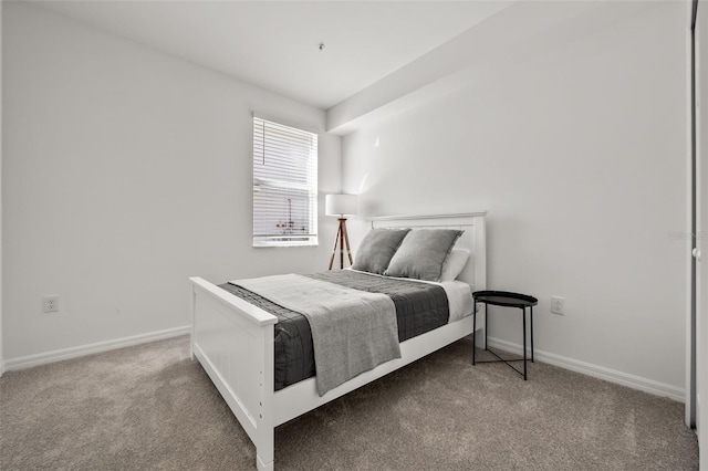 bedroom featuring baseboards and carpet