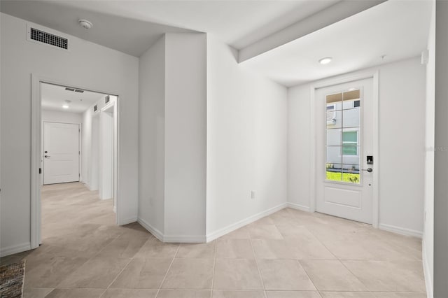 entrance foyer with light tile patterned floors, visible vents, and baseboards