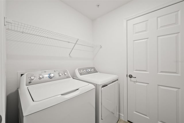 clothes washing area featuring washer and dryer and laundry area