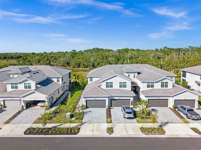 aerial view featuring a forest view and a residential view