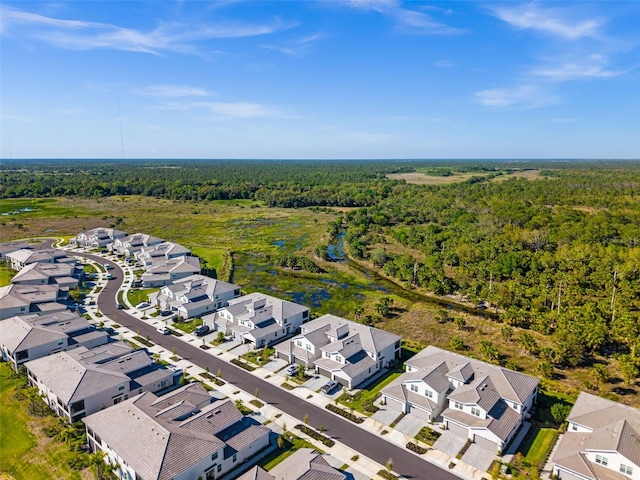 drone / aerial view with a forest view and a residential view