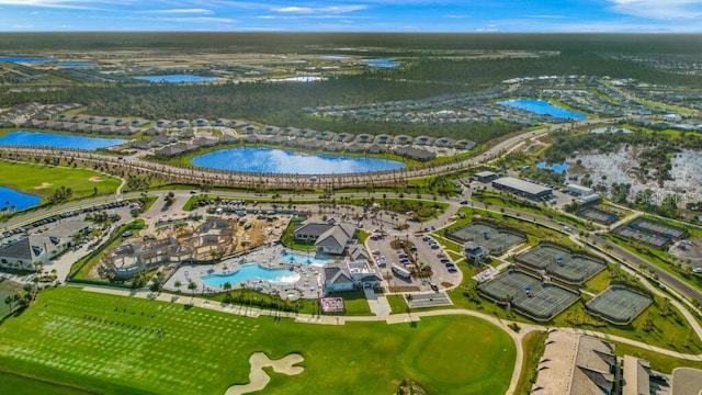 aerial view with golf course view and a water view