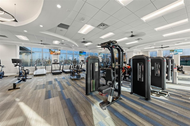 exercise room featuring carpet flooring, baseboards, and visible vents