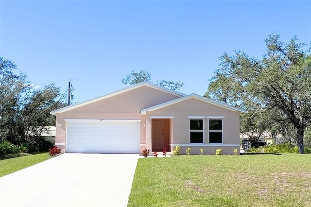 view of front of property with a front lawn, an attached garage, driveway, and stucco siding