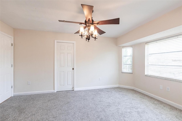 carpeted spare room with baseboards and ceiling fan