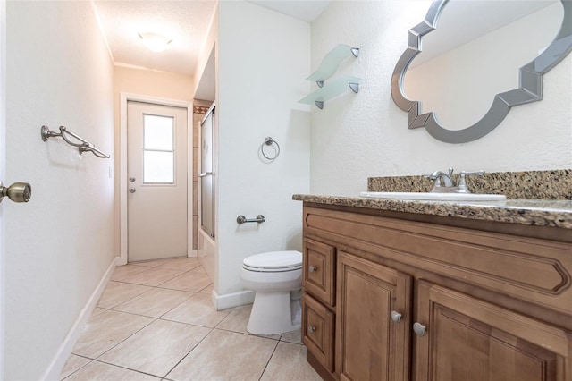 full bathroom featuring baseboards, toilet, tile patterned floors, combined bath / shower with glass door, and vanity