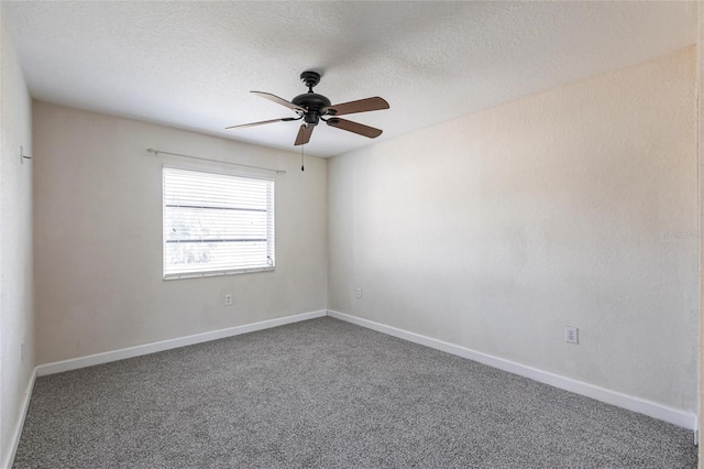 empty room with baseboards, a textured ceiling, and carpet flooring