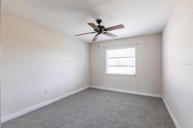 carpeted empty room with baseboards, a textured ceiling, and ceiling fan