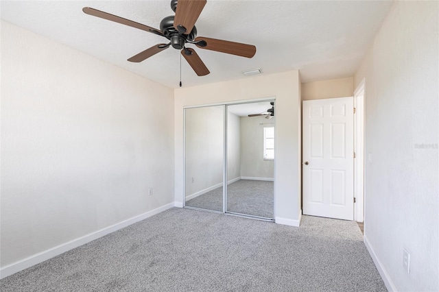 unfurnished bedroom featuring visible vents, baseboards, carpet, and a closet