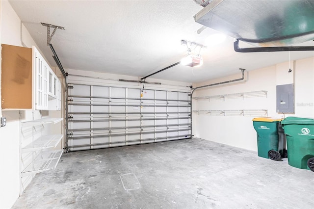 garage with electric panel and a garage door opener