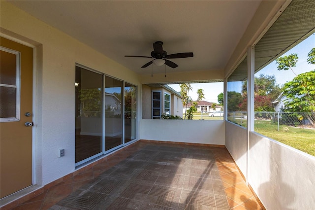 exterior space featuring a ceiling fan and fence