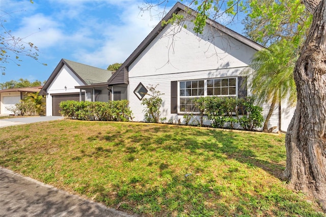 view of front of house featuring a garage, brick siding, concrete driveway, and a front lawn