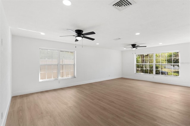 empty room featuring visible vents, light wood finished floors, baseboards, recessed lighting, and ceiling fan