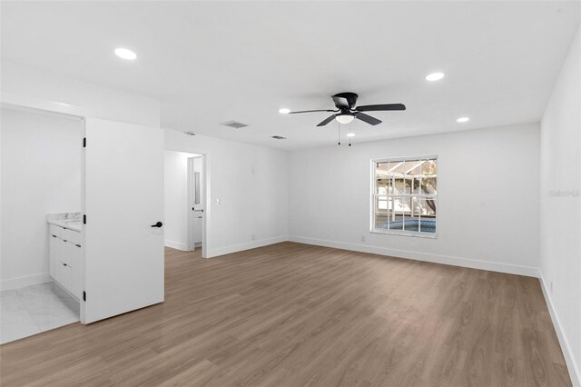 empty room with visible vents, baseboards, recessed lighting, light wood-style flooring, and a ceiling fan