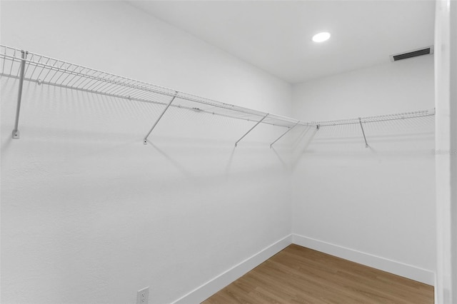 walk in closet featuring visible vents and wood finished floors