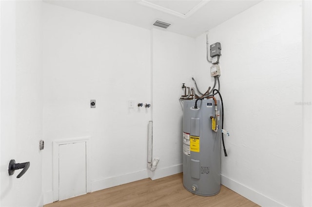 utility room featuring visible vents and water heater