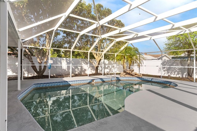 view of pool with a lanai, a fenced backyard, a fenced in pool, and a patio