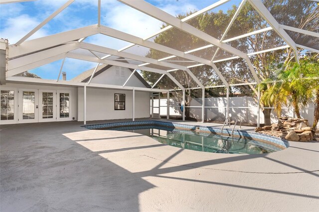 view of pool with a fenced in pool, fence, a lanai, french doors, and a patio area