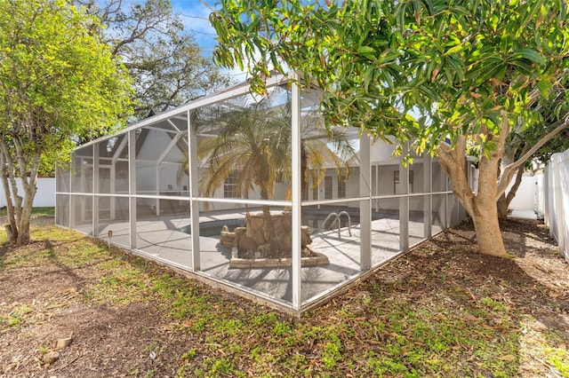 exterior space featuring a patio area, a fenced in pool, a lanai, and a fenced backyard