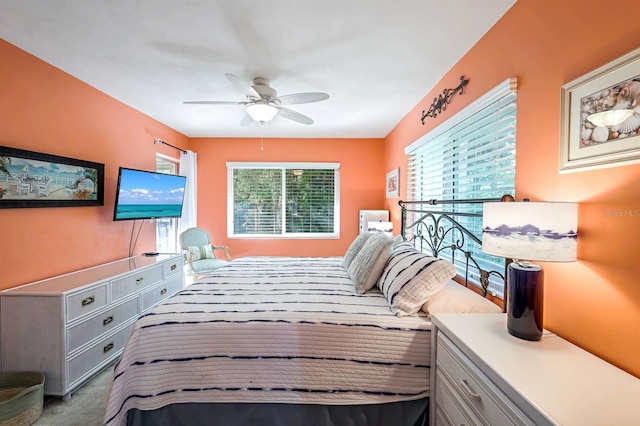 bedroom featuring multiple windows, a ceiling fan, and carpet floors