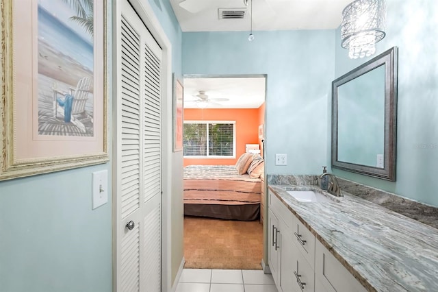 bathroom featuring a closet, visible vents, tile patterned floors, and vanity