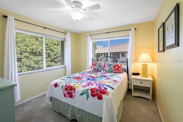 carpeted bedroom with a ceiling fan and baseboards