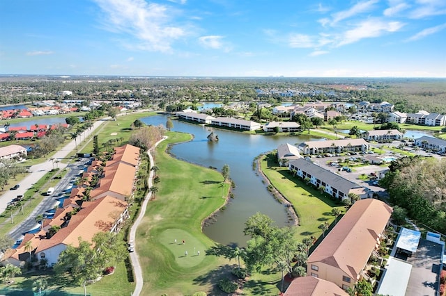 drone / aerial view featuring a residential view, a water view, and golf course view