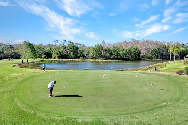 surrounding community featuring view of golf course and a water view