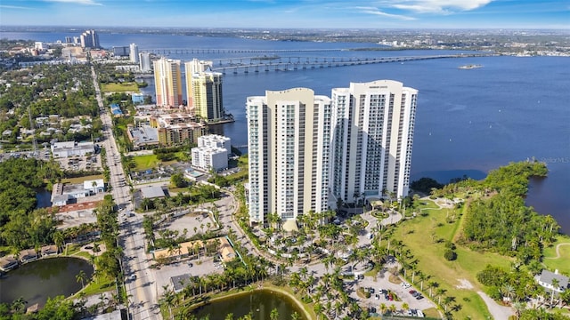 birds eye view of property featuring a city view and a water view