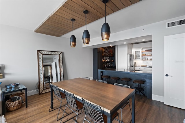 dining room featuring visible vents, baseboards, a community bar, recessed lighting, and wood finished floors