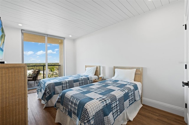 bedroom with baseboards, a wall of windows, recessed lighting, wooden ceiling, and wood finished floors