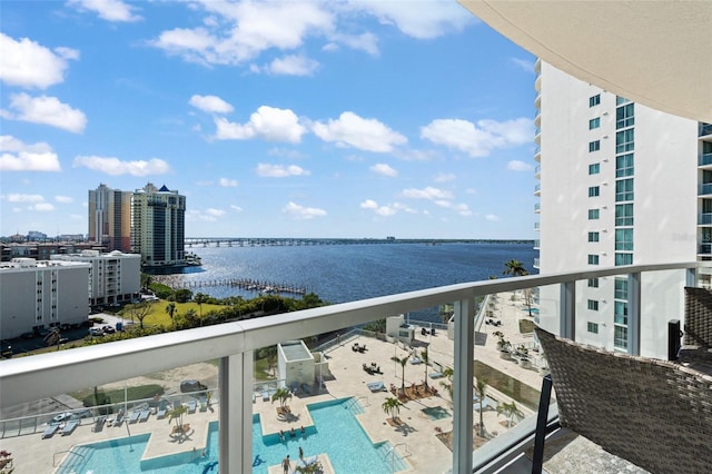 balcony with a view of city and a water view