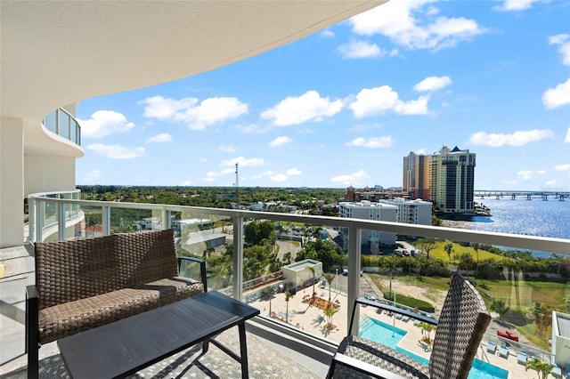 balcony featuring a view of city and a water view