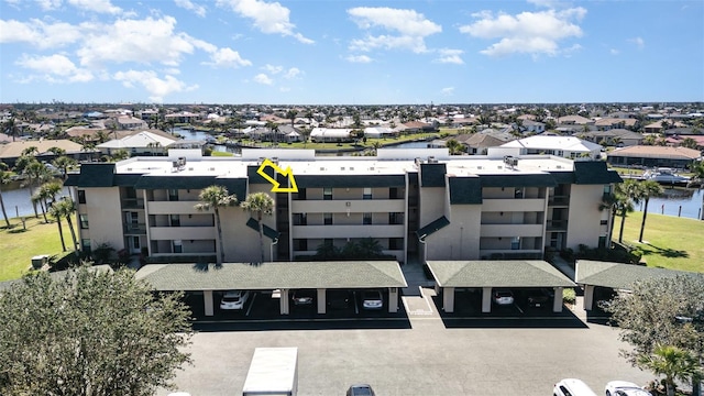 birds eye view of property featuring a residential view and a water view