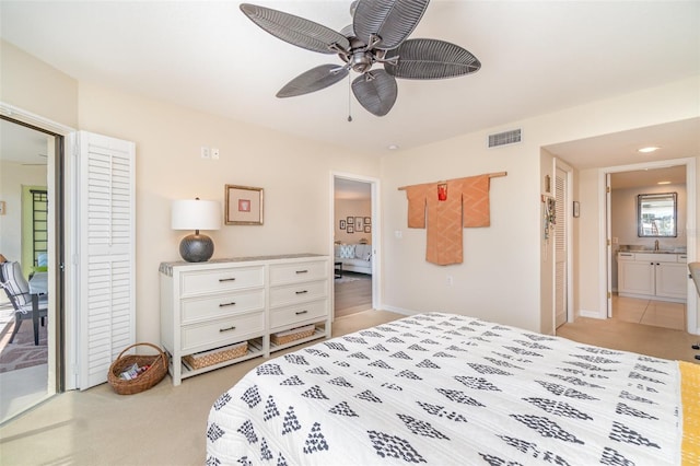 bedroom featuring visible vents, access to exterior, ensuite bath, light colored carpet, and ceiling fan